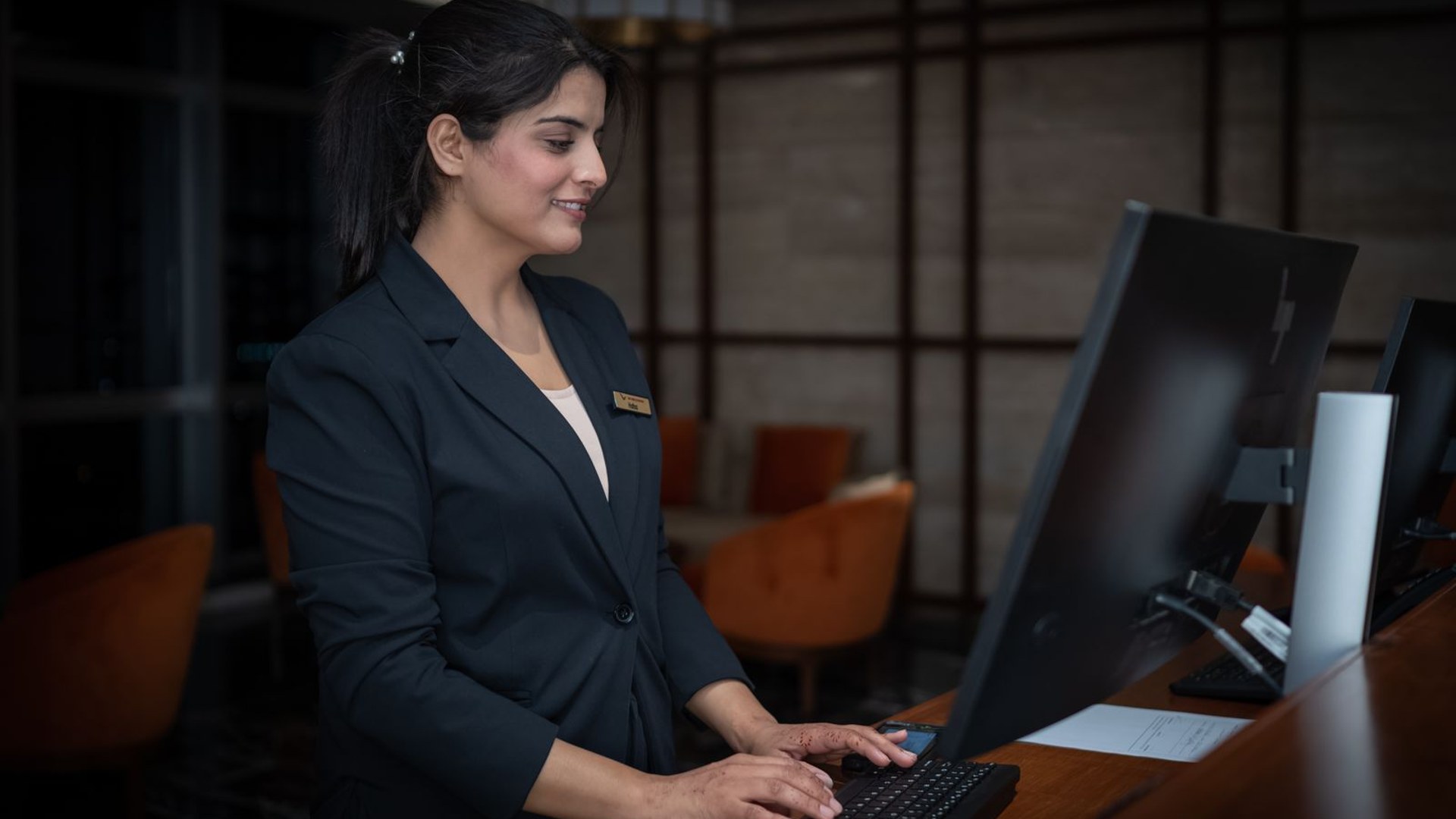 A host at a hotel front desk, where the Create code is displayed